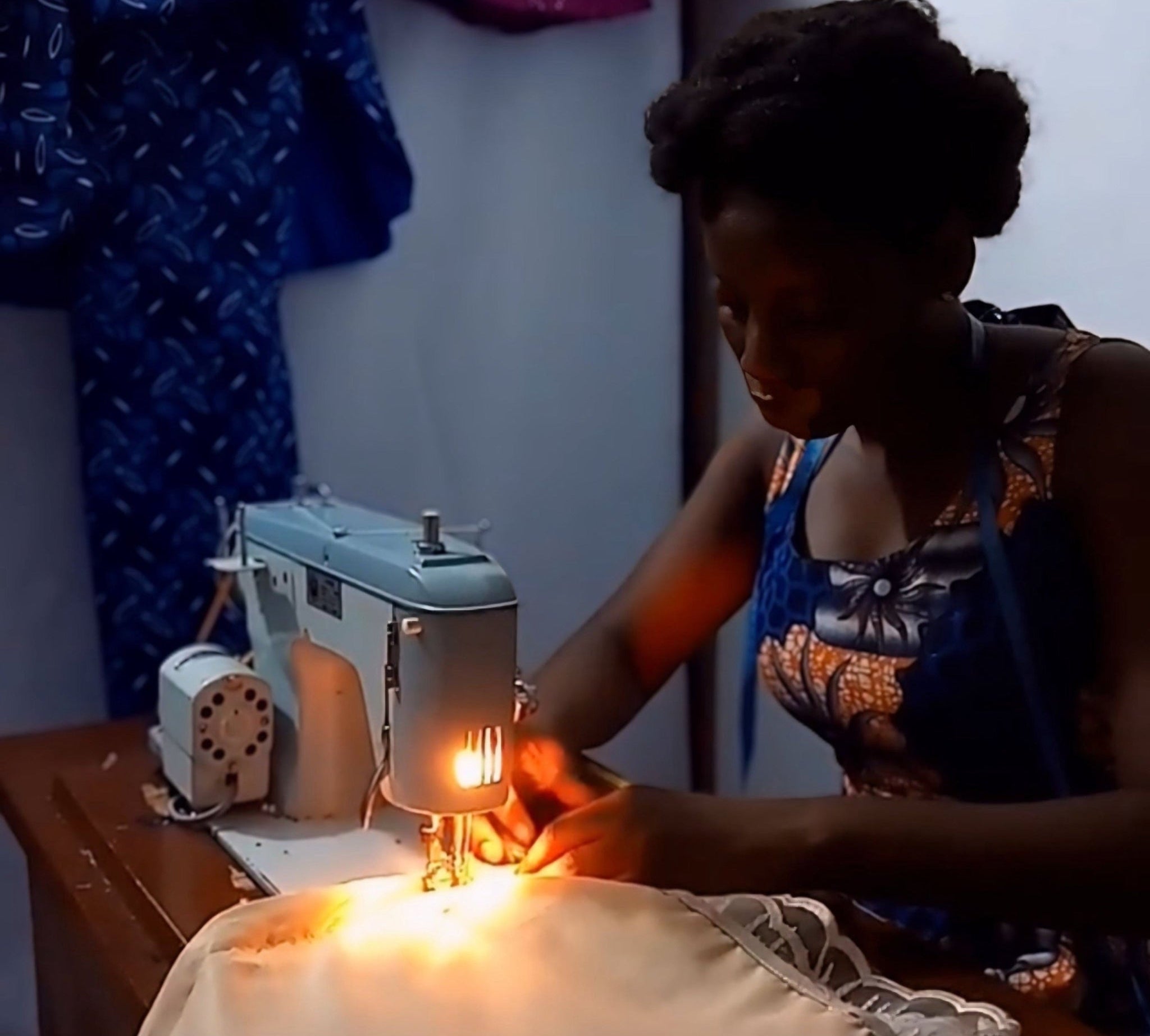 an african artisan making african cultural outfit.