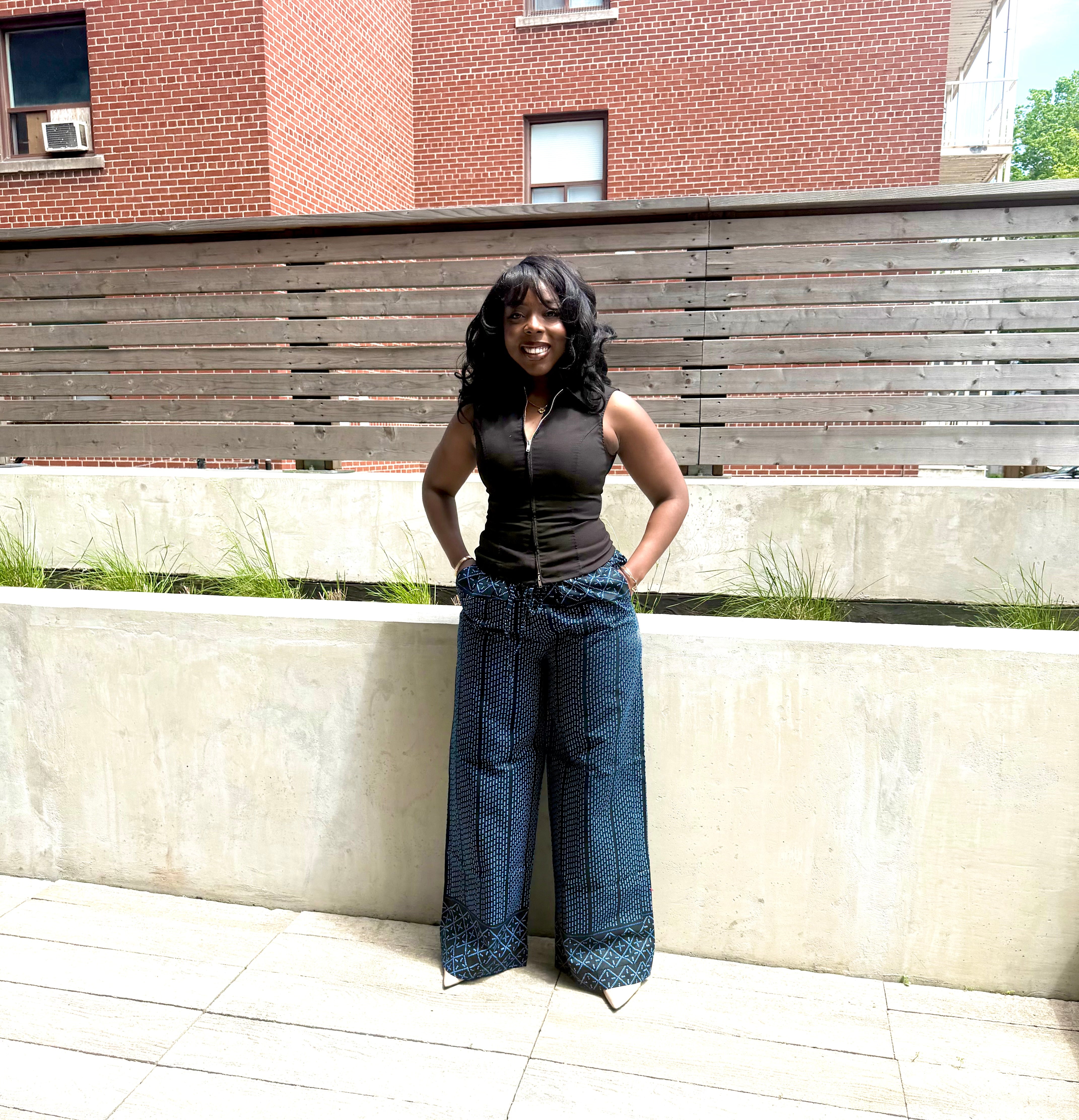 Dark Adaza wide-leg pants, modelled outdoors with a white top.