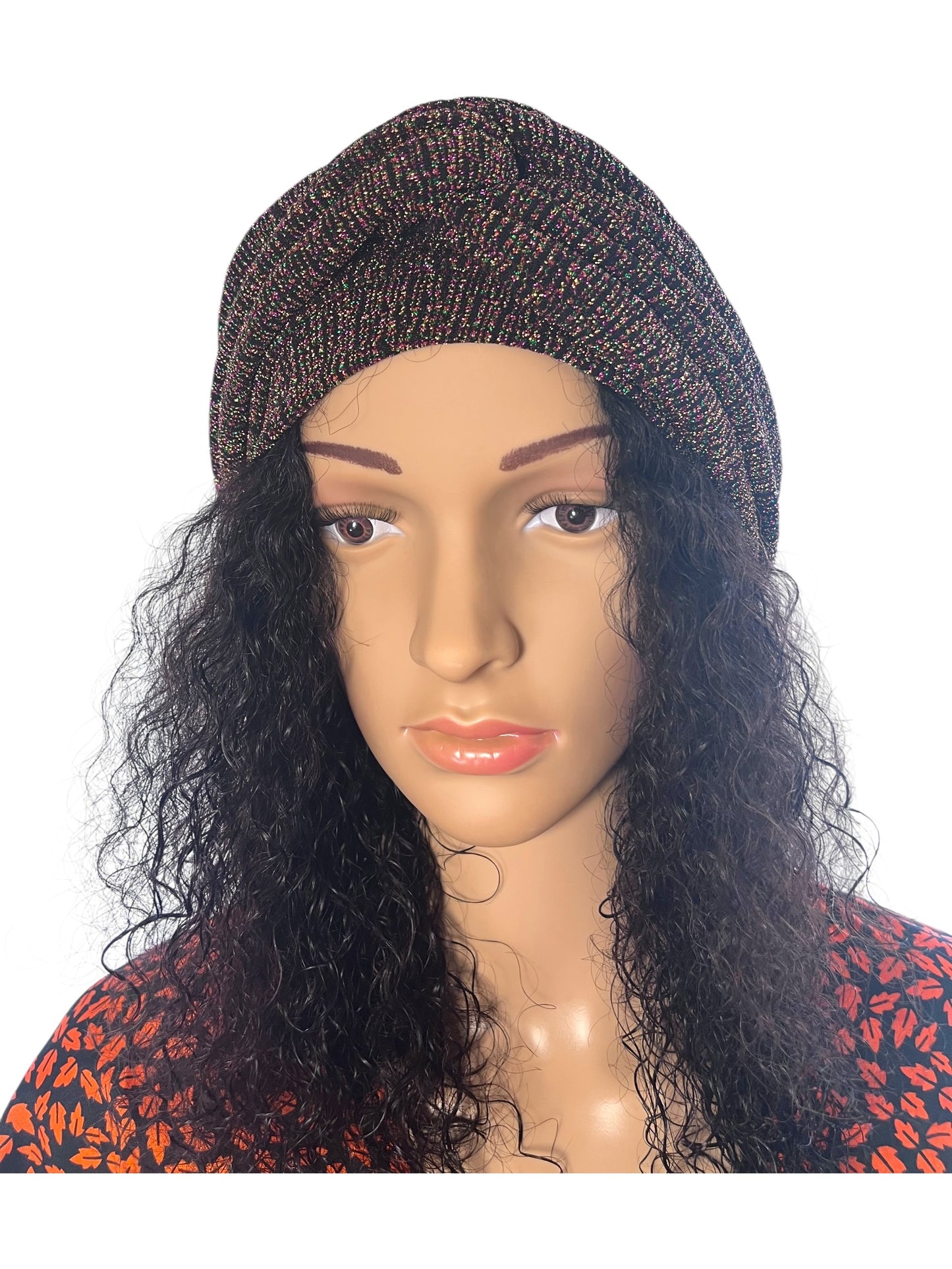Mannequin head with a brown knit turban and long black wig on a white background